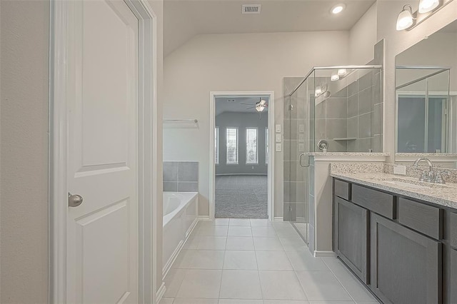 bathroom featuring vaulted ceiling, plus walk in shower, tile patterned flooring, vanity, and ceiling fan