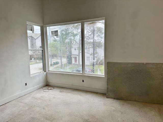 unfurnished room featuring baseboards