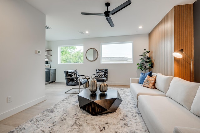 living room featuring visible vents, baseboards, light wood-type flooring, recessed lighting, and a ceiling fan