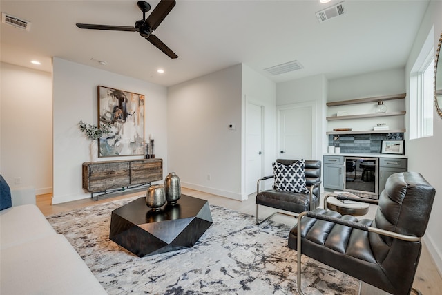 living room with recessed lighting, visible vents, and light wood finished floors