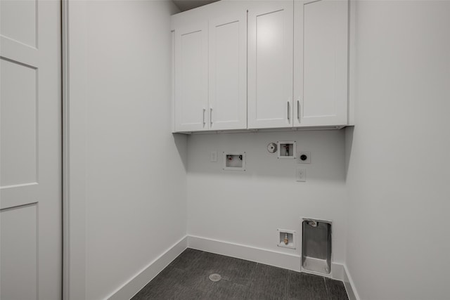 clothes washing area with baseboards, gas dryer hookup, washer hookup, cabinet space, and electric dryer hookup