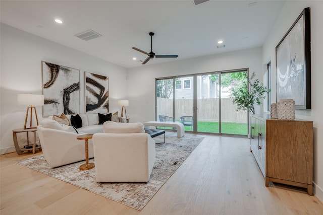 living room featuring recessed lighting, light wood-style floors, and visible vents