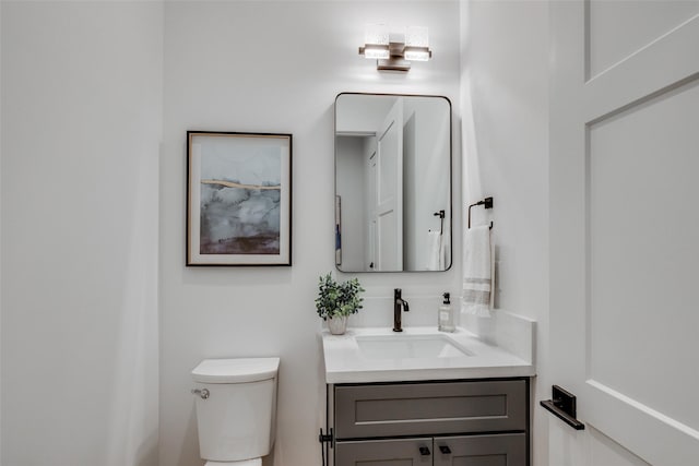 half bath featuring toilet and vanity