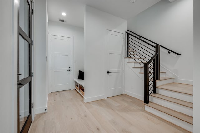 staircase featuring recessed lighting, wood finished floors, visible vents, and baseboards