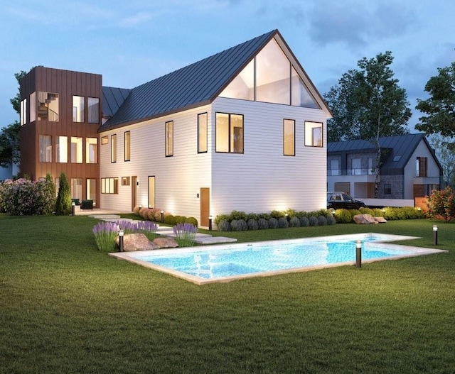 back of house with an outdoor pool, a standing seam roof, a lawn, and metal roof