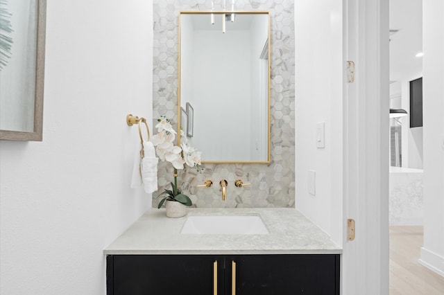 bathroom featuring vanity and decorative backsplash