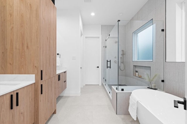 bathroom featuring tile patterned floors, vanity, plus walk in shower, and tile walls