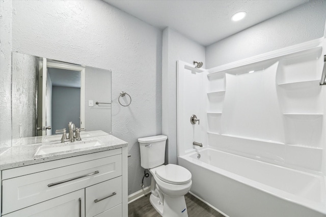 full bathroom featuring shower / washtub combination, wood-type flooring, vanity, and toilet