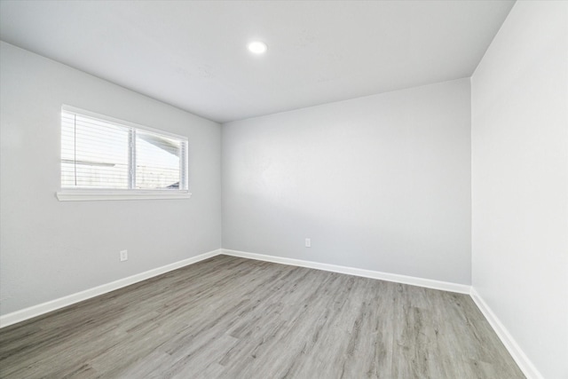 empty room with light hardwood / wood-style flooring