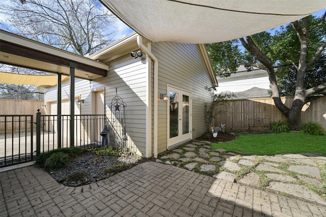 view of patio with a garage and french doors