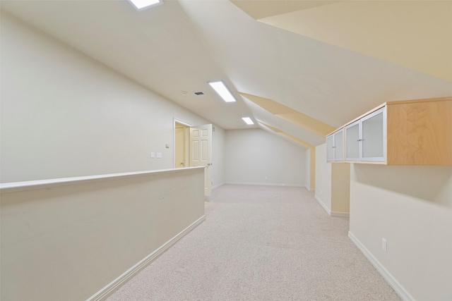 additional living space featuring light carpet and lofted ceiling