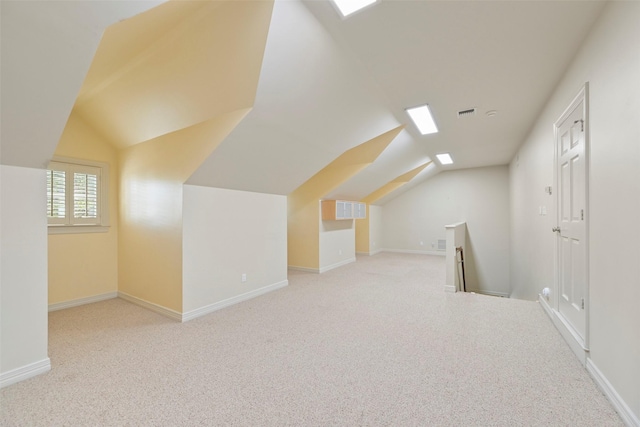 additional living space featuring vaulted ceiling and light carpet