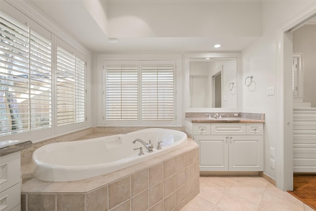 bathroom featuring vanity, tile patterned flooring, and tiled bath