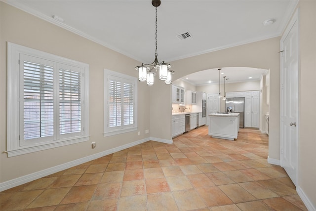 kitchen with white cabinetry, crown molding, a center island, pendant lighting, and stainless steel appliances