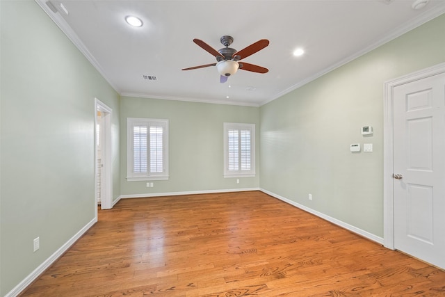 spare room with ceiling fan, ornamental molding, and light hardwood / wood-style floors