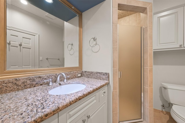 bathroom featuring walk in shower, vanity, and toilet