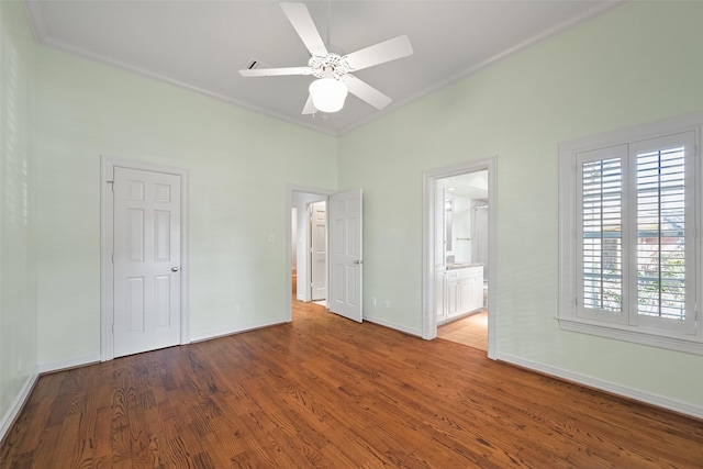 unfurnished bedroom with ceiling fan, ensuite bath, ornamental molding, and hardwood / wood-style floors