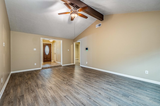 unfurnished living room with lofted ceiling with beams, dark hardwood / wood-style floors, a textured ceiling, and ceiling fan