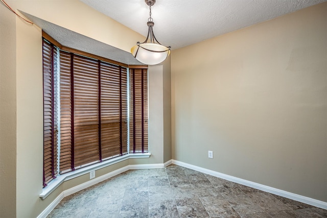 spare room with a textured ceiling