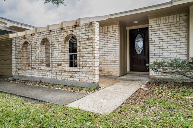 doorway to property with a garage