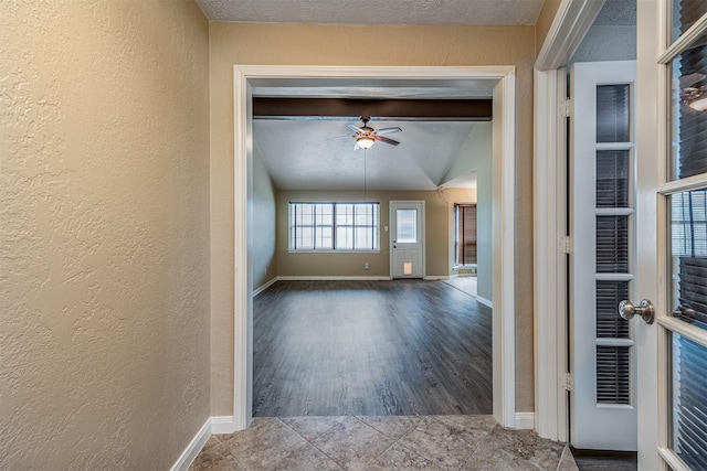 interior space featuring ceiling fan and a textured ceiling