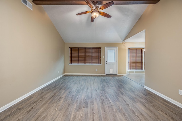 unfurnished living room featuring lofted ceiling with beams, hardwood / wood-style floors, a textured ceiling, and ceiling fan