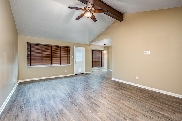 unfurnished living room with lofted ceiling with beams, ceiling fan, hardwood / wood-style floors, and a textured ceiling