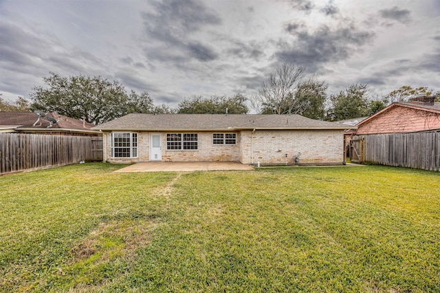 rear view of house featuring a patio and a lawn