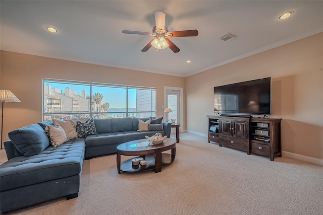 carpeted living area with visible vents, recessed lighting, crown molding, and baseboards