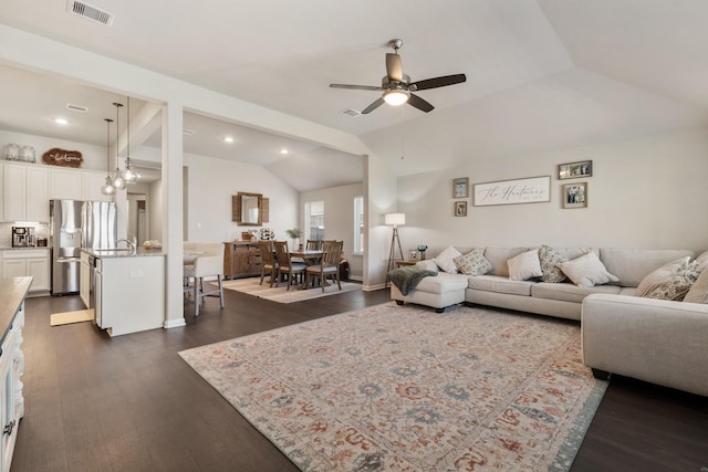 living area featuring recessed lighting, dark wood-type flooring, visible vents, a ceiling fan, and vaulted ceiling