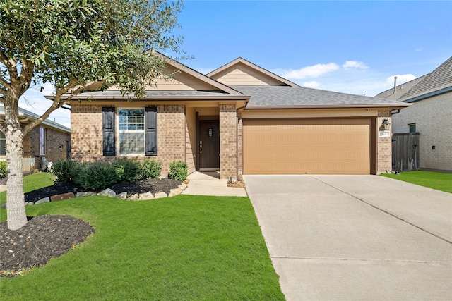 ranch-style home with a garage, a front lawn, concrete driveway, and brick siding