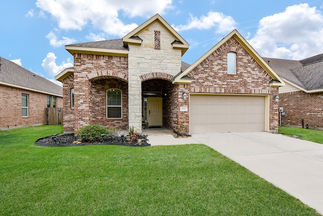 view of front of property featuring a garage and a front lawn