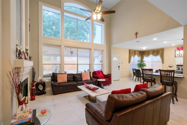 living room featuring a towering ceiling and ceiling fan
