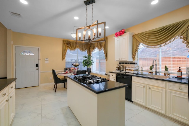 kitchen featuring pendant lighting, sink, black appliances, a kitchen island, and a chandelier