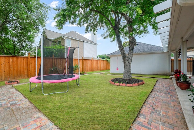 view of yard with a patio and a trampoline