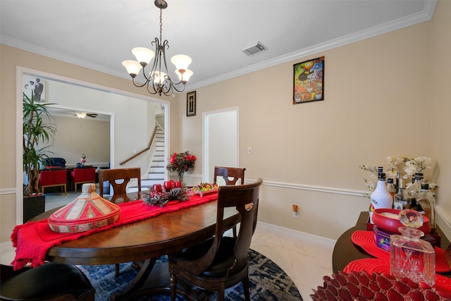 dining space with ornamental molding and a chandelier