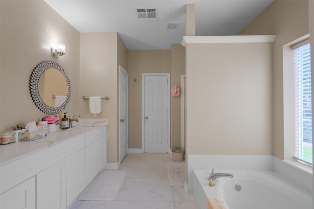 bathroom with plenty of natural light, vanity, and a tub