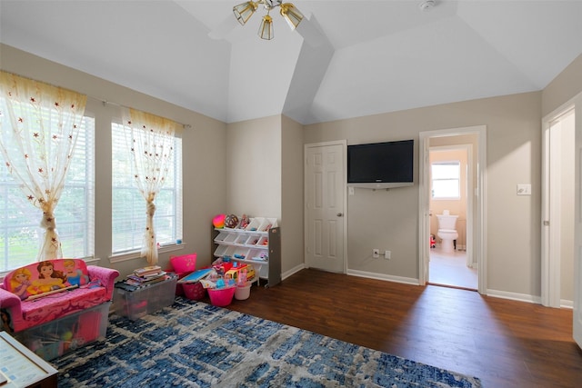 playroom featuring dark wood-type flooring, ceiling fan, and lofted ceiling