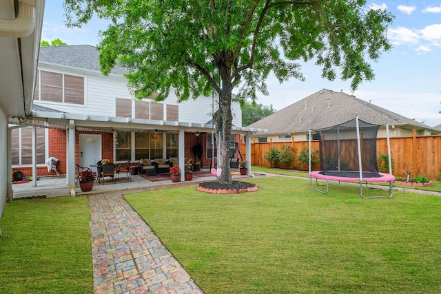 view of yard featuring a trampoline and a patio area
