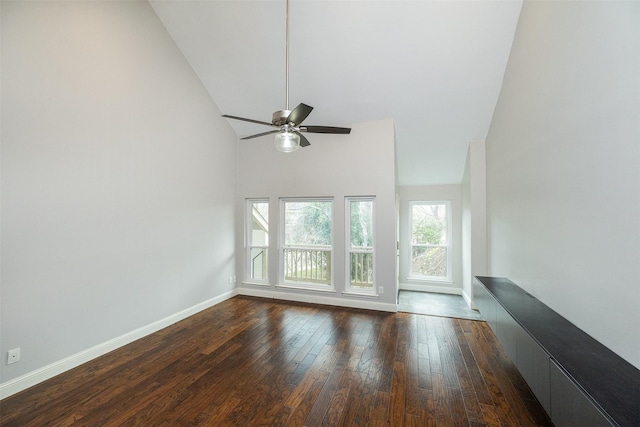 unfurnished living room with dark wood-type flooring, ceiling fan, and high vaulted ceiling