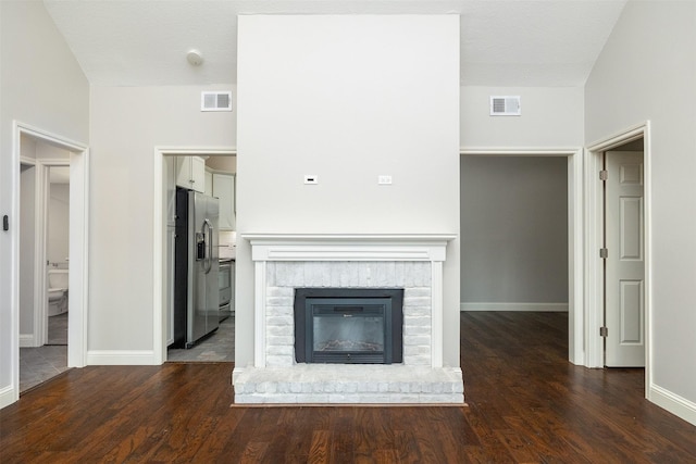 unfurnished living room with dark hardwood / wood-style floors and a fireplace