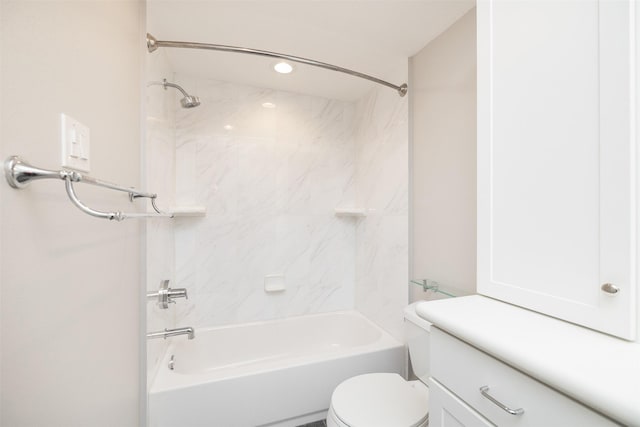 full bathroom featuring tiled shower / bath, vanity, and toilet