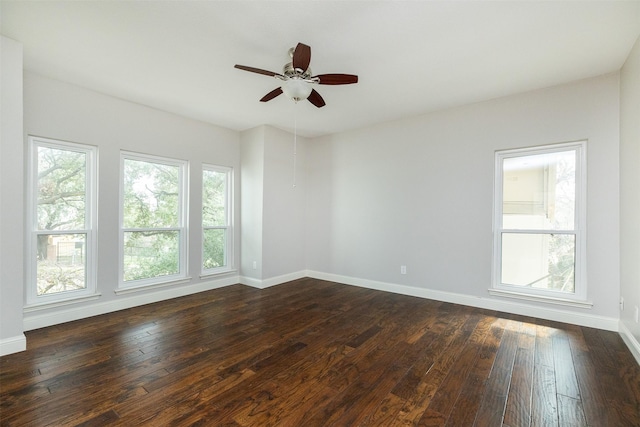 spare room with dark hardwood / wood-style flooring and ceiling fan