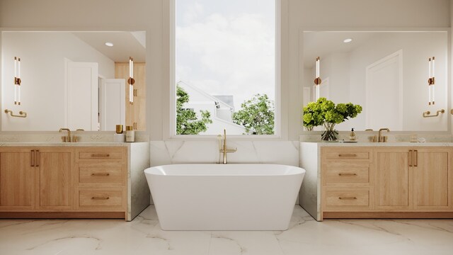 bathroom featuring vanity and a washtub