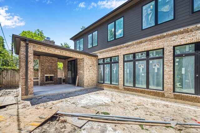 1615 Milford St, Houston, TX 77006 - rear view of property with a patio area, brick siding, and fence