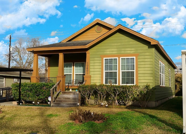 bungalow-style home with covered porch and a front lawn