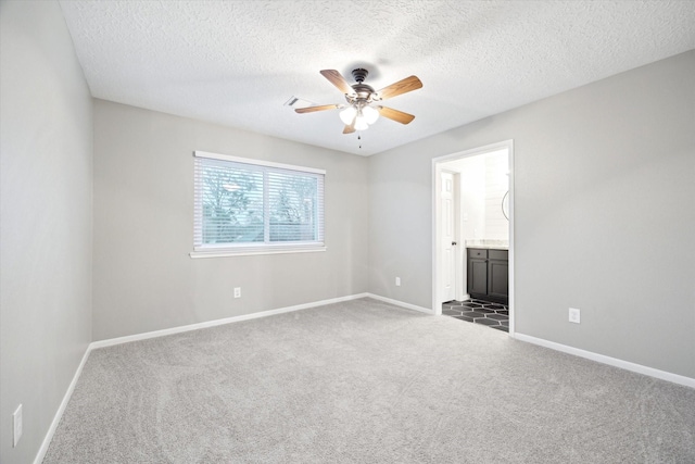 interior space featuring dark colored carpet, a textured ceiling, and ceiling fan