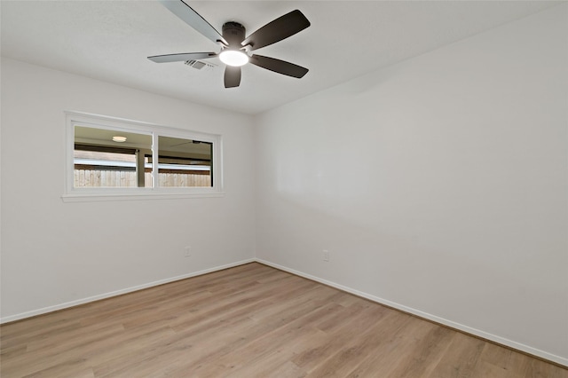 spare room with ceiling fan and light hardwood / wood-style flooring