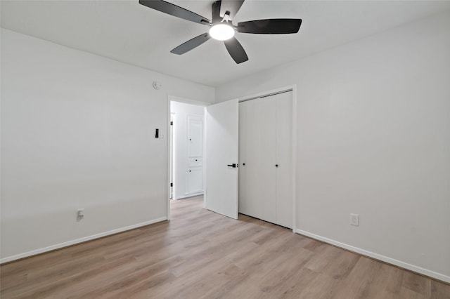 unfurnished bedroom with ceiling fan, light hardwood / wood-style floors, and a closet