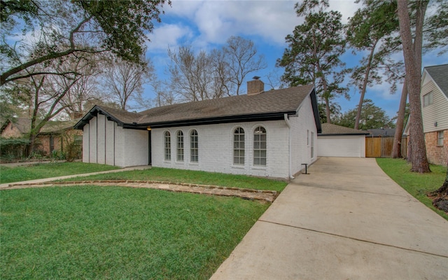 ranch-style home featuring a garage and a front lawn